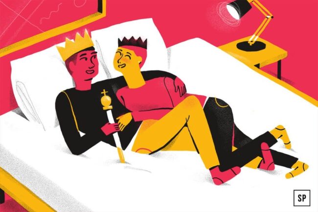 Zwei Cartoon-Personen mit Kronen und bunten Kleidern kuscheln lächelnd und entspannt auf der besten Matratze. Einer hält ein Zepter. Neben dem Bett steht ein gelber Nachttisch mit einer Lampe. Die Szene ist verspielt und warm.