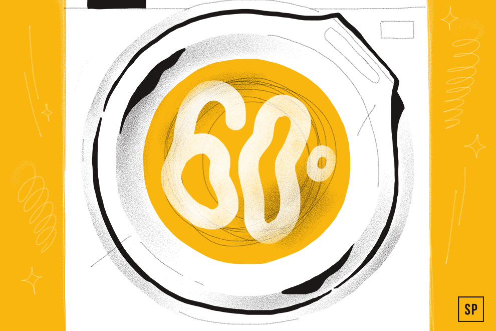 Illustration einer Waschmaschinentrommel mit der Zahl 60° in großer weißer Schrift auf gelbem Hintergrund, die auf eine 60-Grad-Wäsche hinweist. Das Bild enthält stilisierte Linien und Glitzer zur Dekoration.