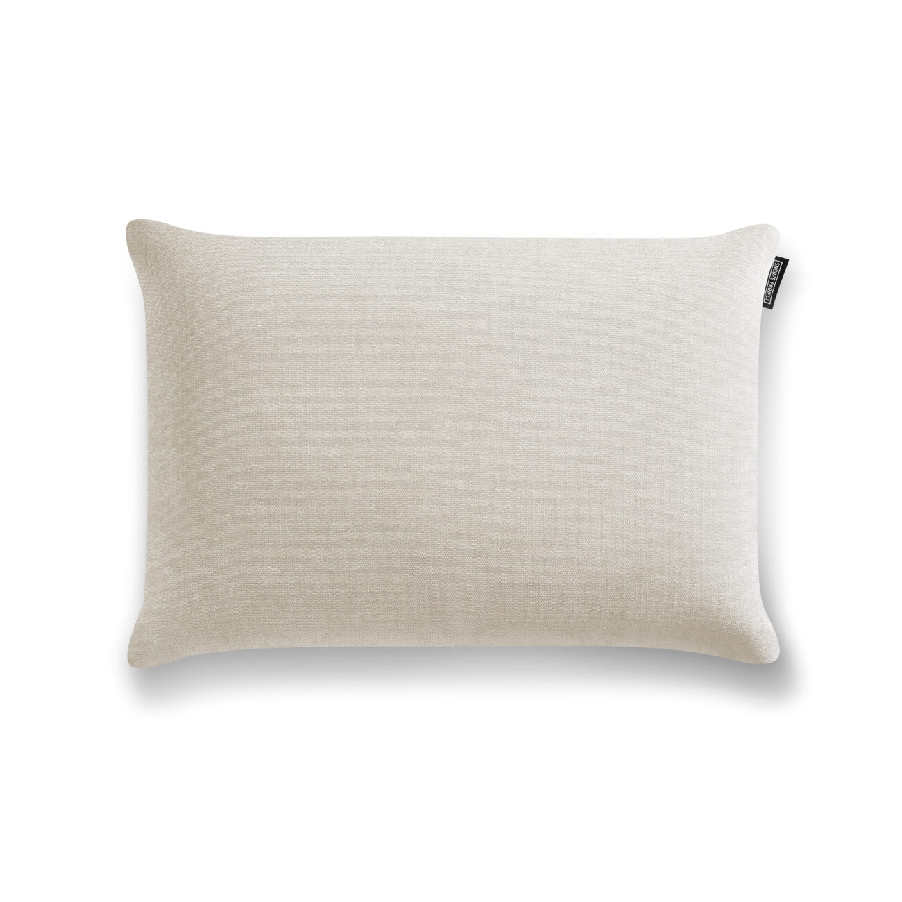 SP_Levi_Kissen_Travertineweiß_01 Ein rechteckiges, hellbeiges Kissen mit einem dezent strukturierten Stoff und einem kleinen schwarzen Etikett auf der oberen rechten Seite, abgebildet auf weißem Hintergrund.